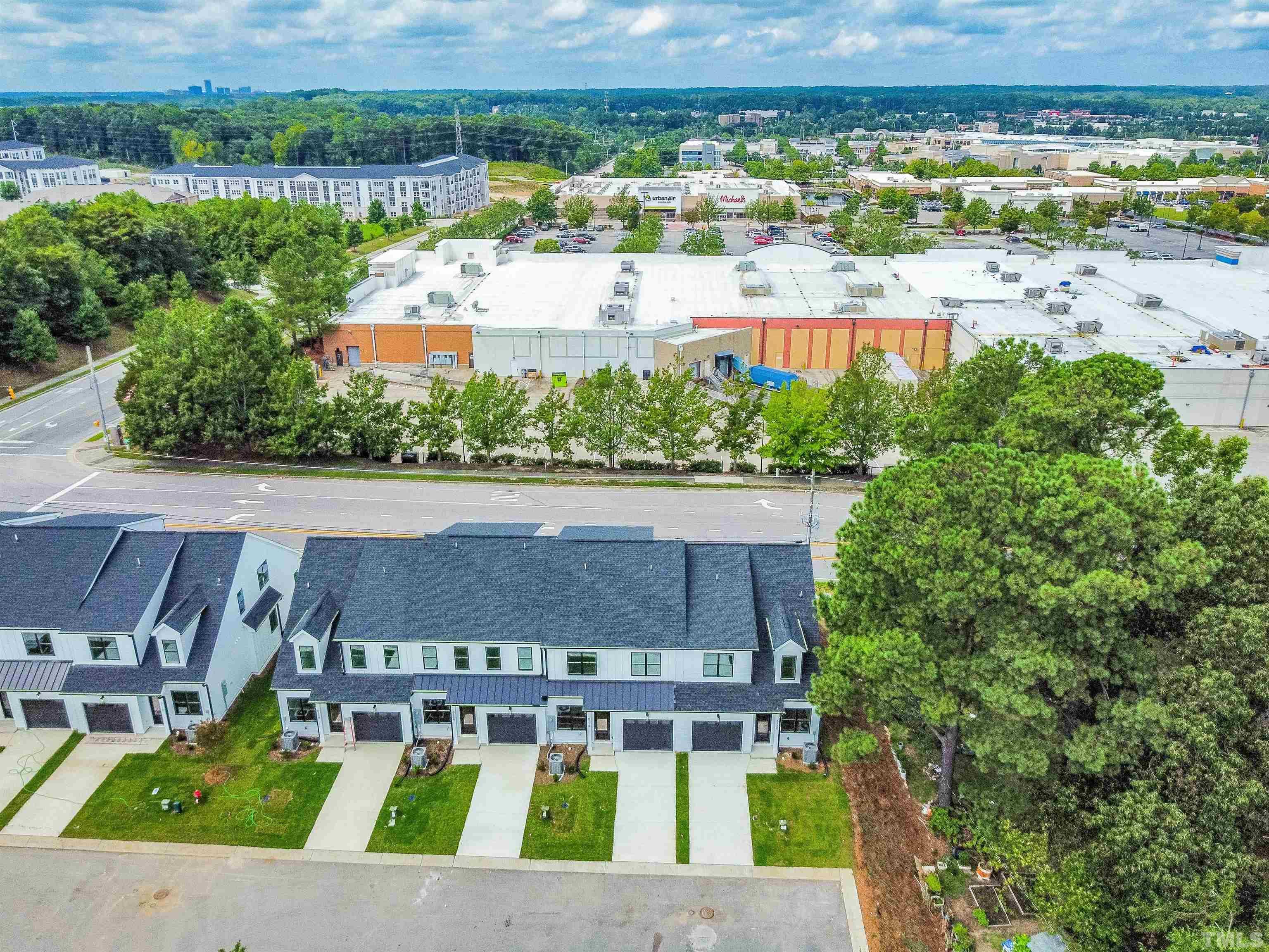 an aerial view of a house with a yard and outdoor seating