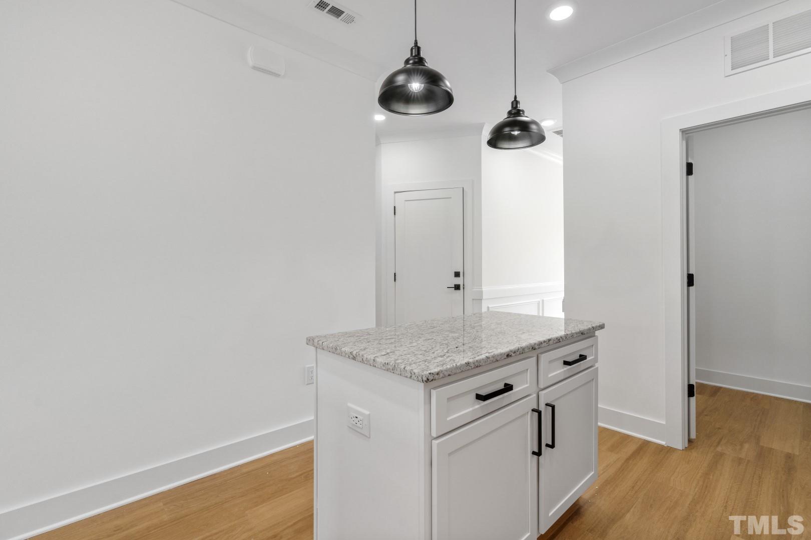 6108 Fox Road Raleigh, NC 27616 - Photo 15 of 40 a kitchen with stainless steel appliances granite countertop white cabinets and wooden floor