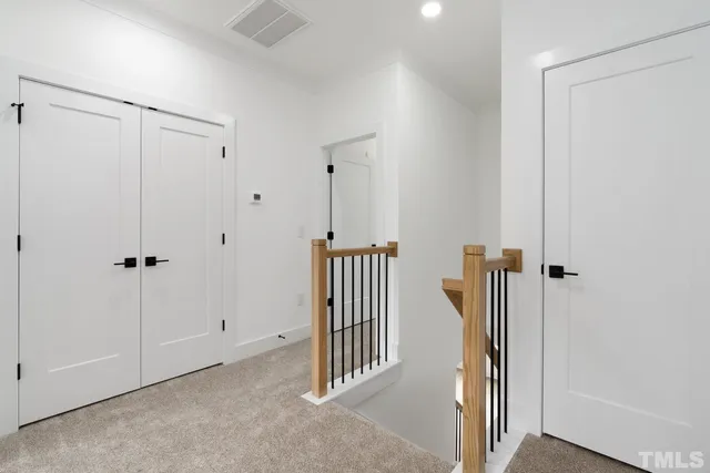 a view of a hallway with entryway door