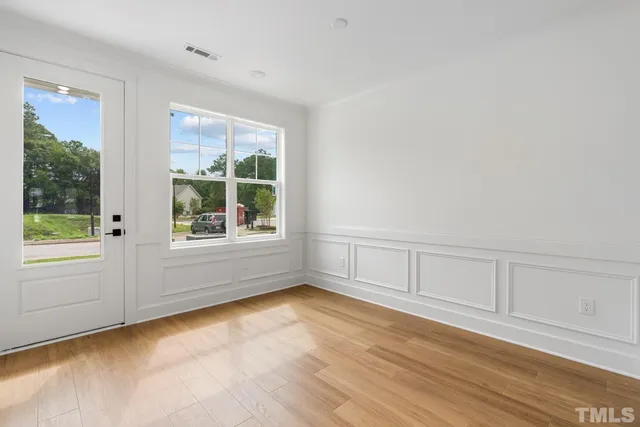 wooden floor in an empty room with a window