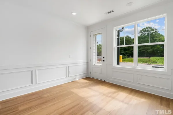 wooden floor in an empty room with a window