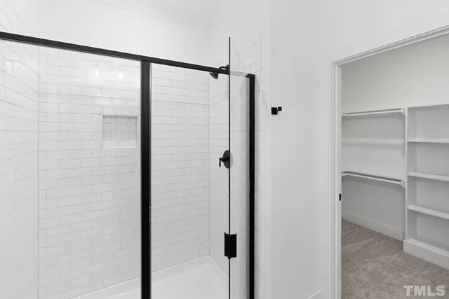 a bathroom with a glass shower door