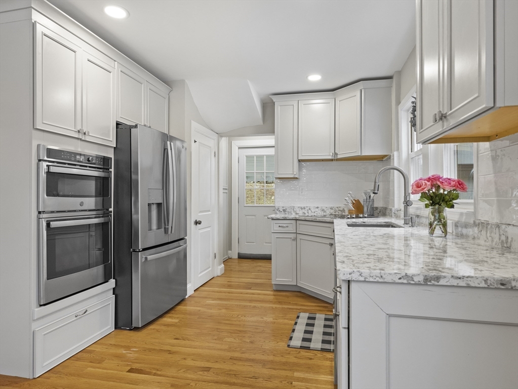 a kitchen with granite countertop stainless steel appliances and counter space