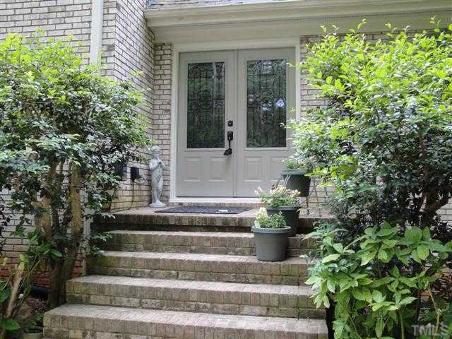 10209 Whitestone Road Raleigh, NC 27615 - Photo 2 of 25 Lanscaped entry way with new energy-efficient door installed May 2010