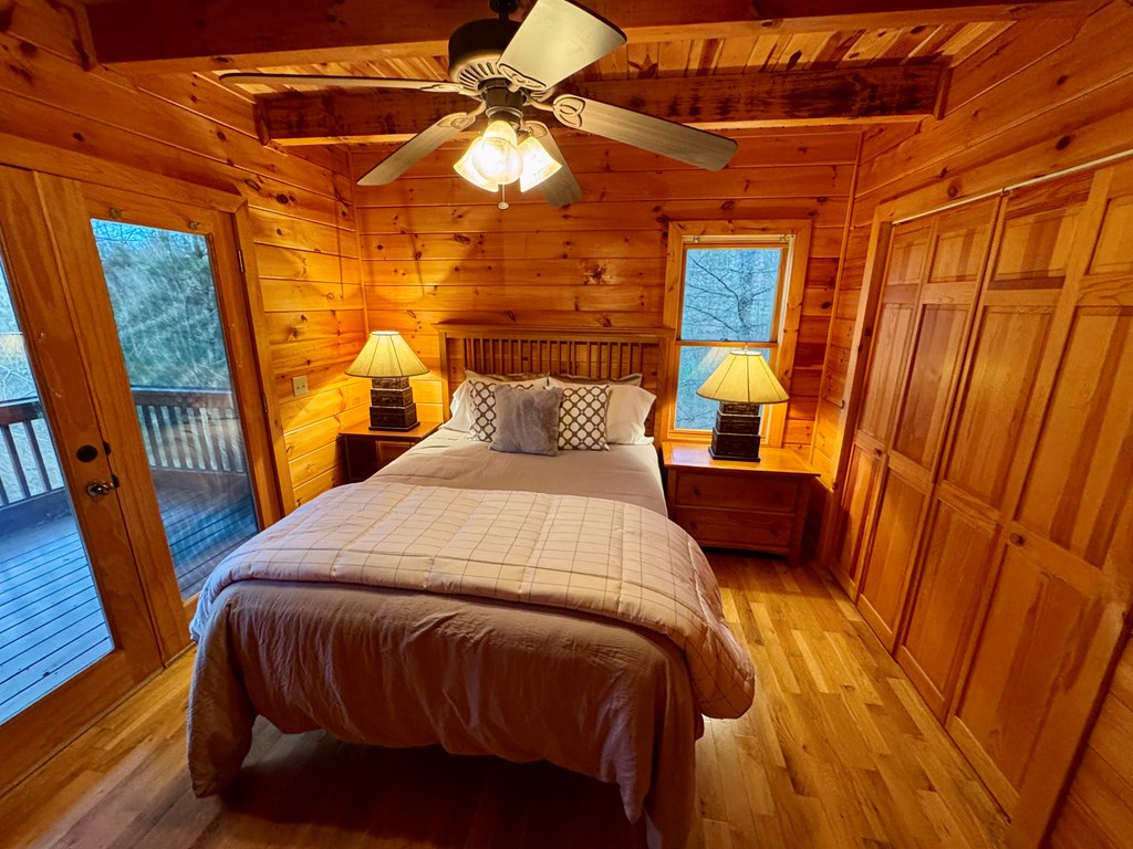 162 Toccoa Overlook Lane Blue Ridge, GA 30513 - Photo 21 of 39 a bedroom with a bed and wooden floor