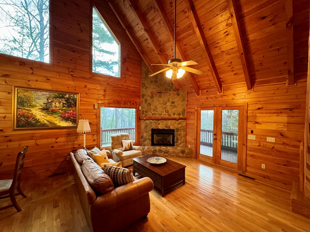 162 Toccoa Overlook Lane Blue Ridge, GA 30513 - Photo 3 of 39 a living room with fireplace furniture and a wooden floor