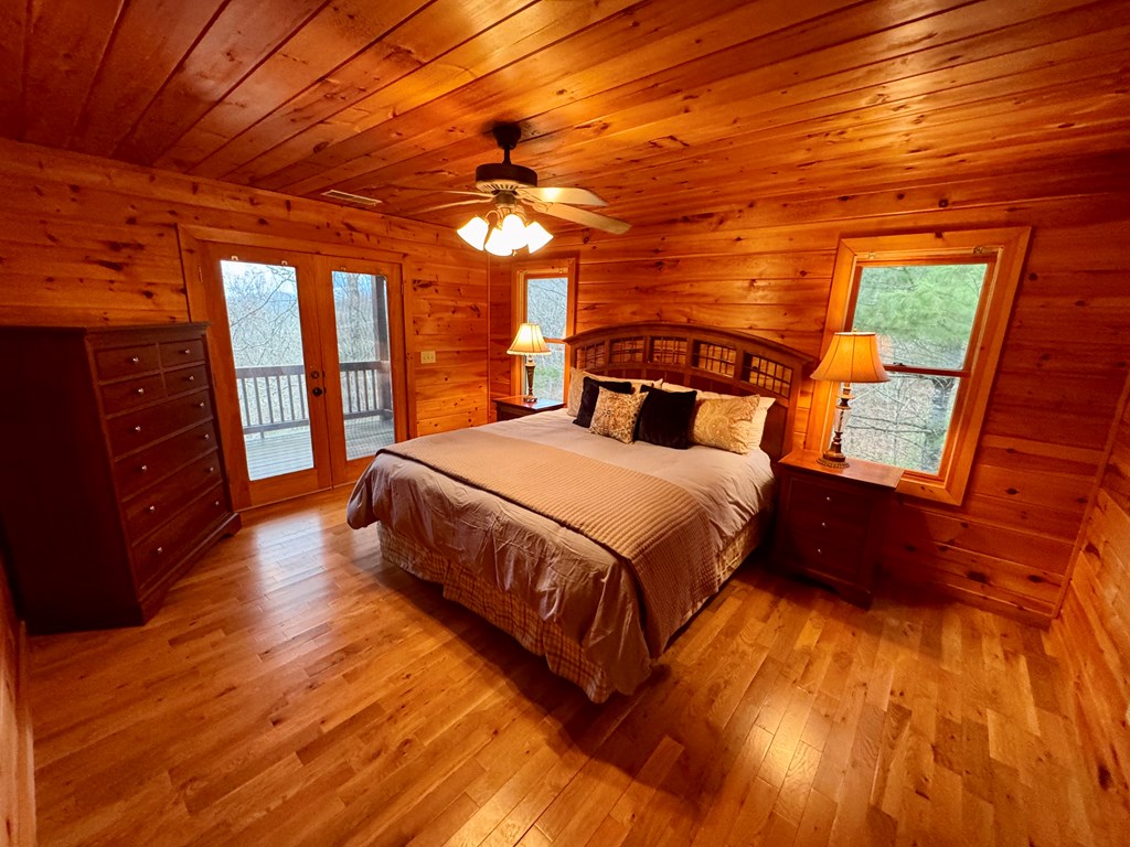 162 Toccoa Overlook Lane Blue Ridge, GA 30513 - Photo 35 of 39 a bedroom with a bed and wooden floors