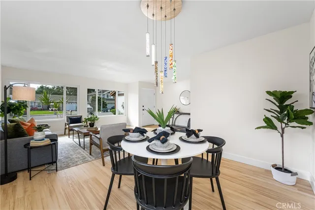 a view of a dining room with furniture window and wooden floor