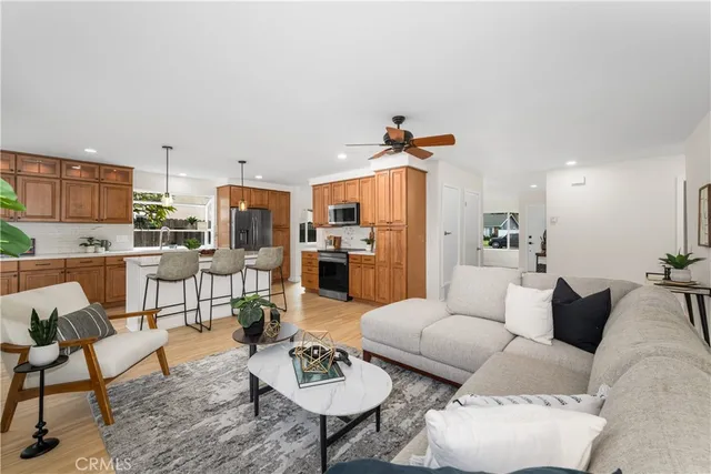 a living room with furniture kitchen view and a table