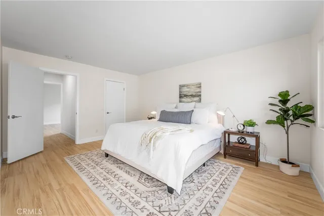 a bedroom with a bed and a potted plant
