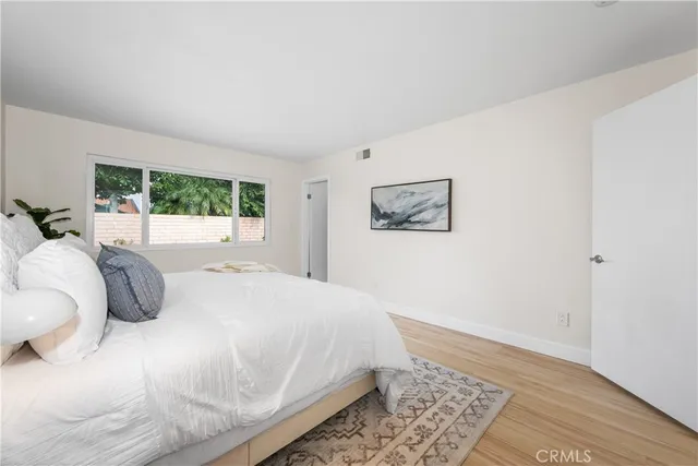 a bedroom with a large bed and a window