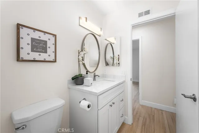 a bathroom with a toilet a sink and a mirror