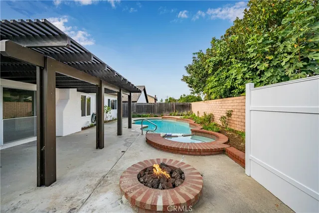 a view of a swimming pool with a patio and a yard