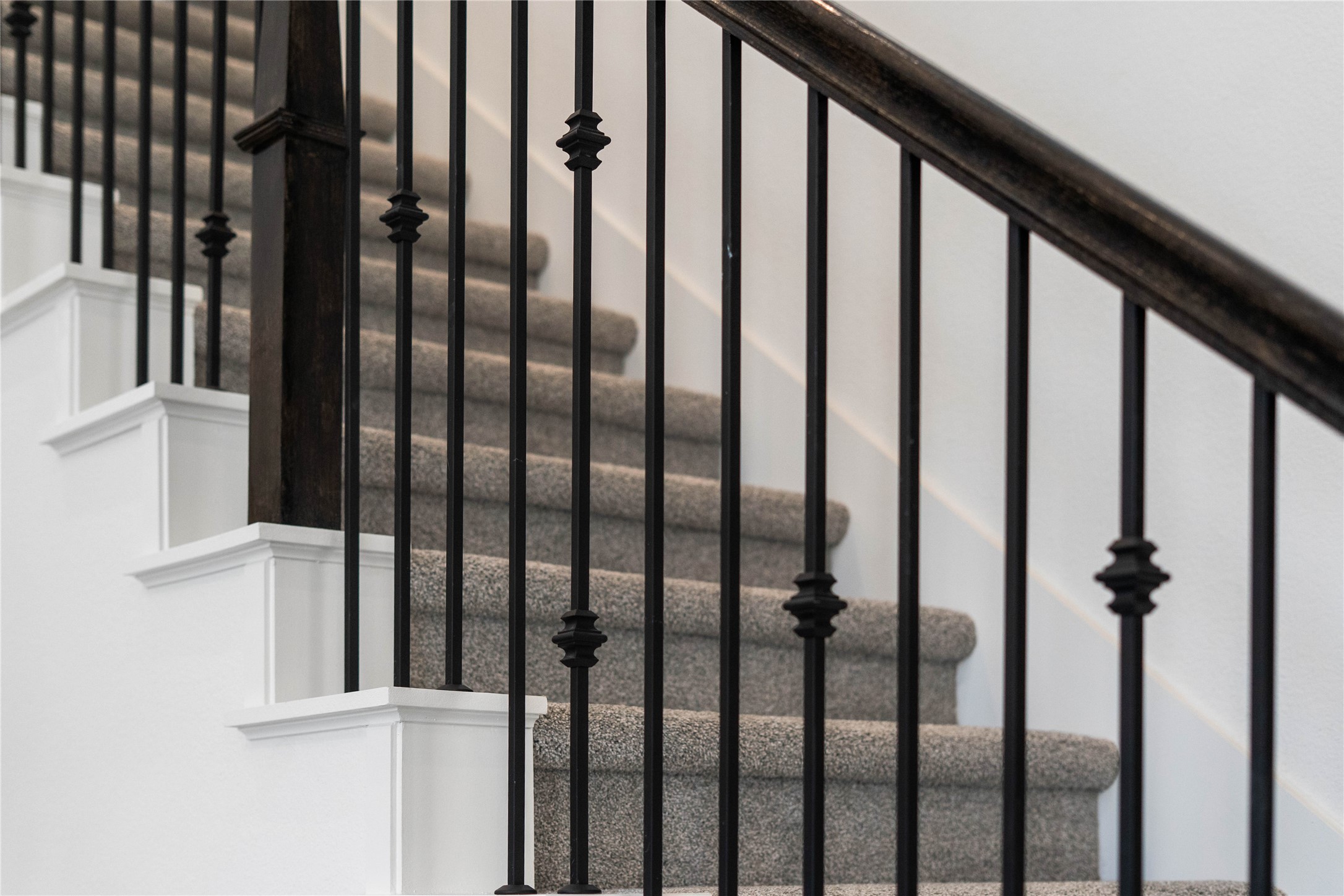 17315 July Moon Lane Conroe, TX 77302 - Photo 32 of 46 Focus on the quality architectural details of this home, including sleek wrought iron balusters and dark wood handrails.