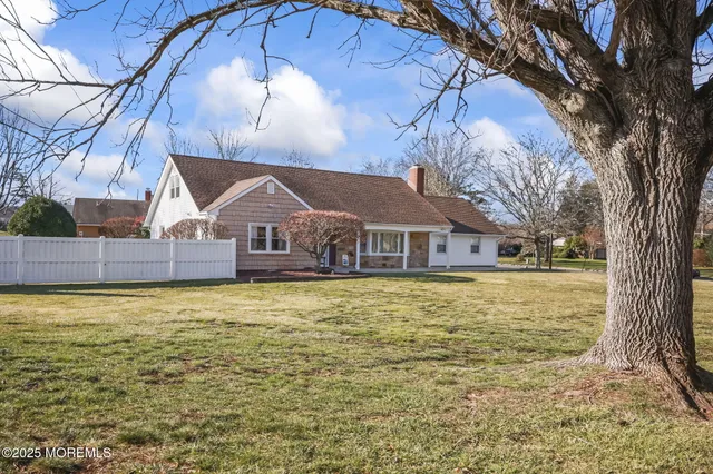 a front view of house with yard and lake view