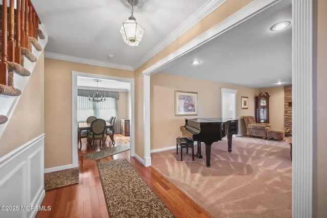 a living room with furniture a dining table and wooden floor
