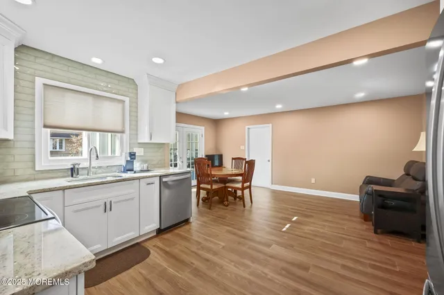 a kitchen with a sink stove and cabinets