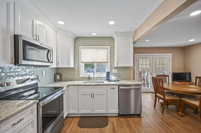 a kitchen with stainless steel appliances granite countertop a refrigerator and a stove top oven