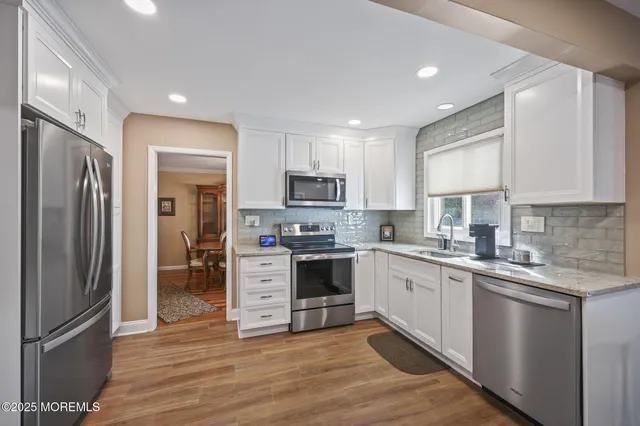 a kitchen with a refrigerator and a stove top oven