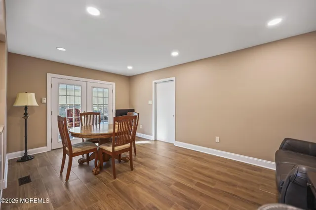 a living room with furniture a dining table and kitchen view