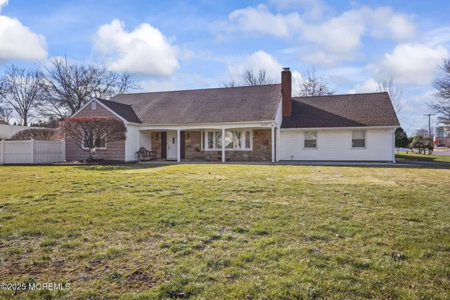 a house view with swimming pool in front of it