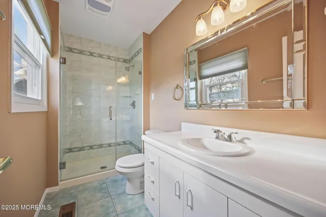 a spacious bathroom with a sink a toilet and a shower