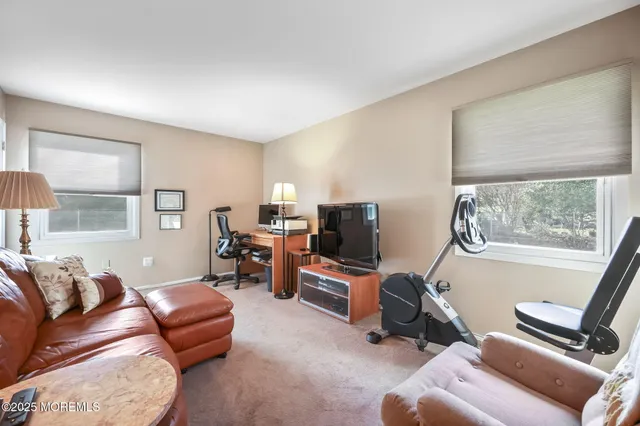 a bedroom with a bed and a window with chair