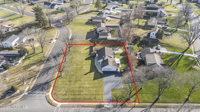 an aerial view of a house with garden space and sitting space