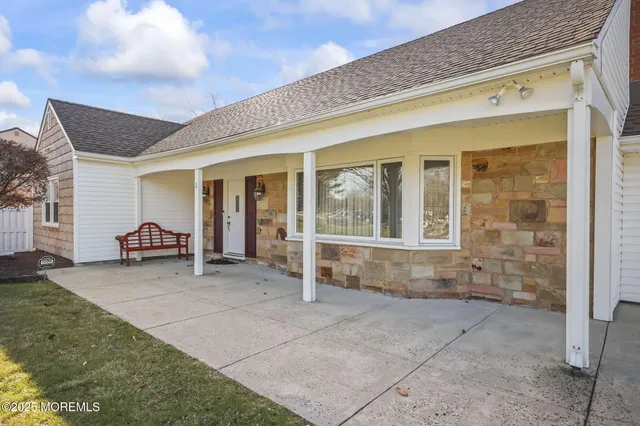 a view of a house with backyard porch and sitting area