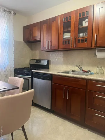 a kitchen with stainless steel appliances granite countertop a sink dishwasher stove and cabinets