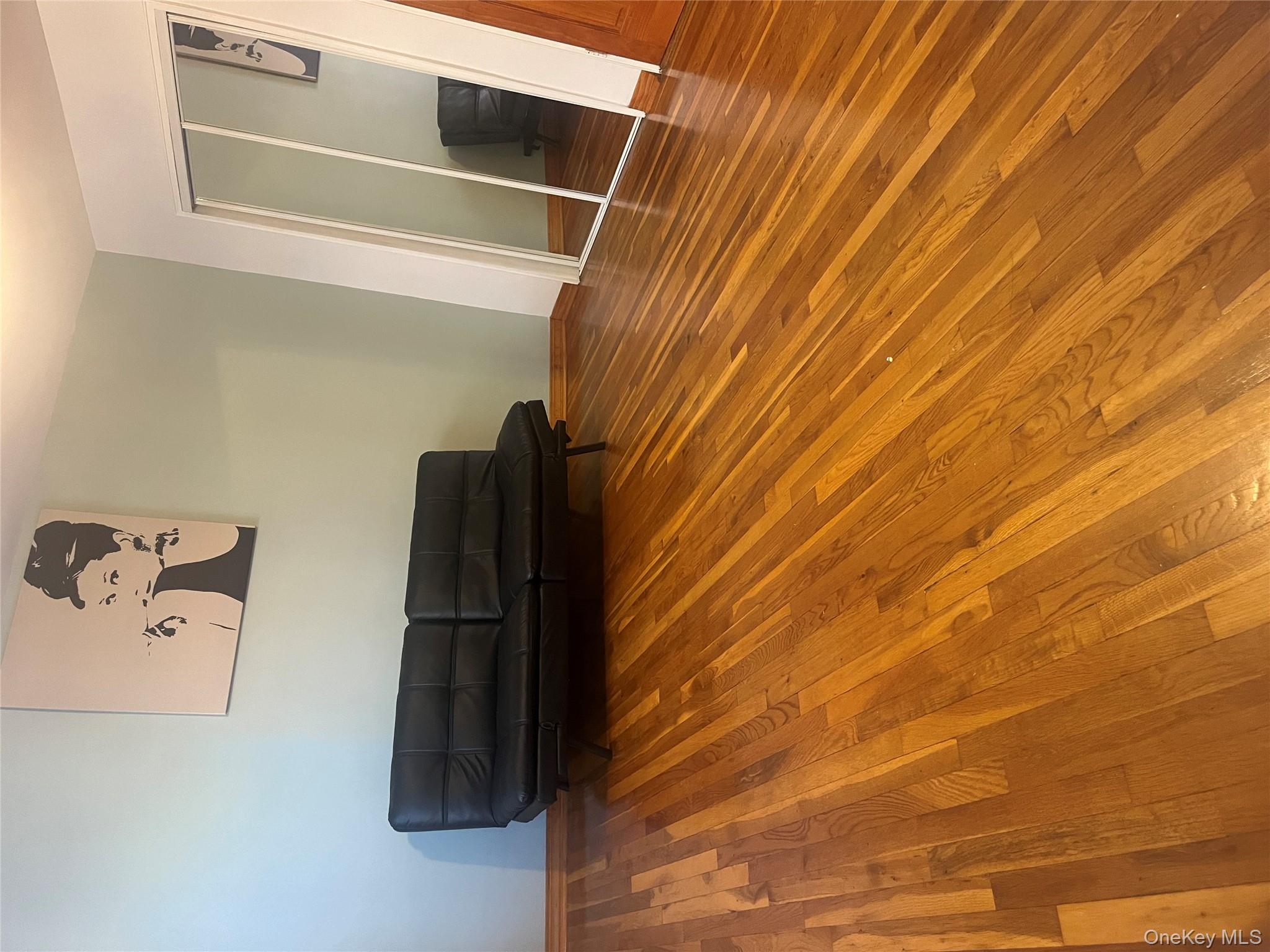 139-15 83rd Avenue, Unit 407 Queens, NY 11435 - Photo 6 of 8 a bedroom with a bed and a walk in closet