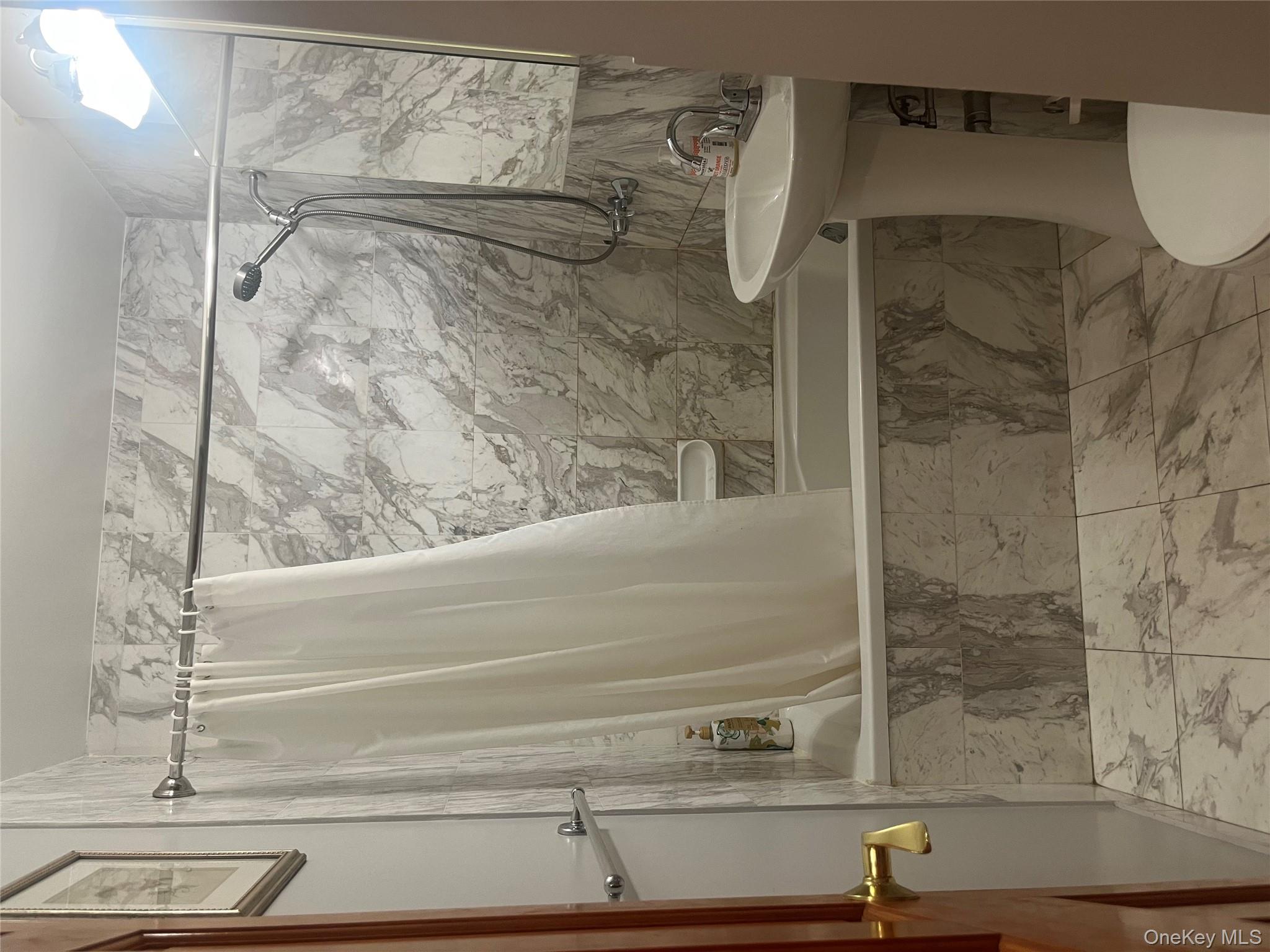 139-15 83rd Avenue, Unit 407 Queens, NY 11435 - Photo 8 of 8 a bathroom with a sink toilet and shower