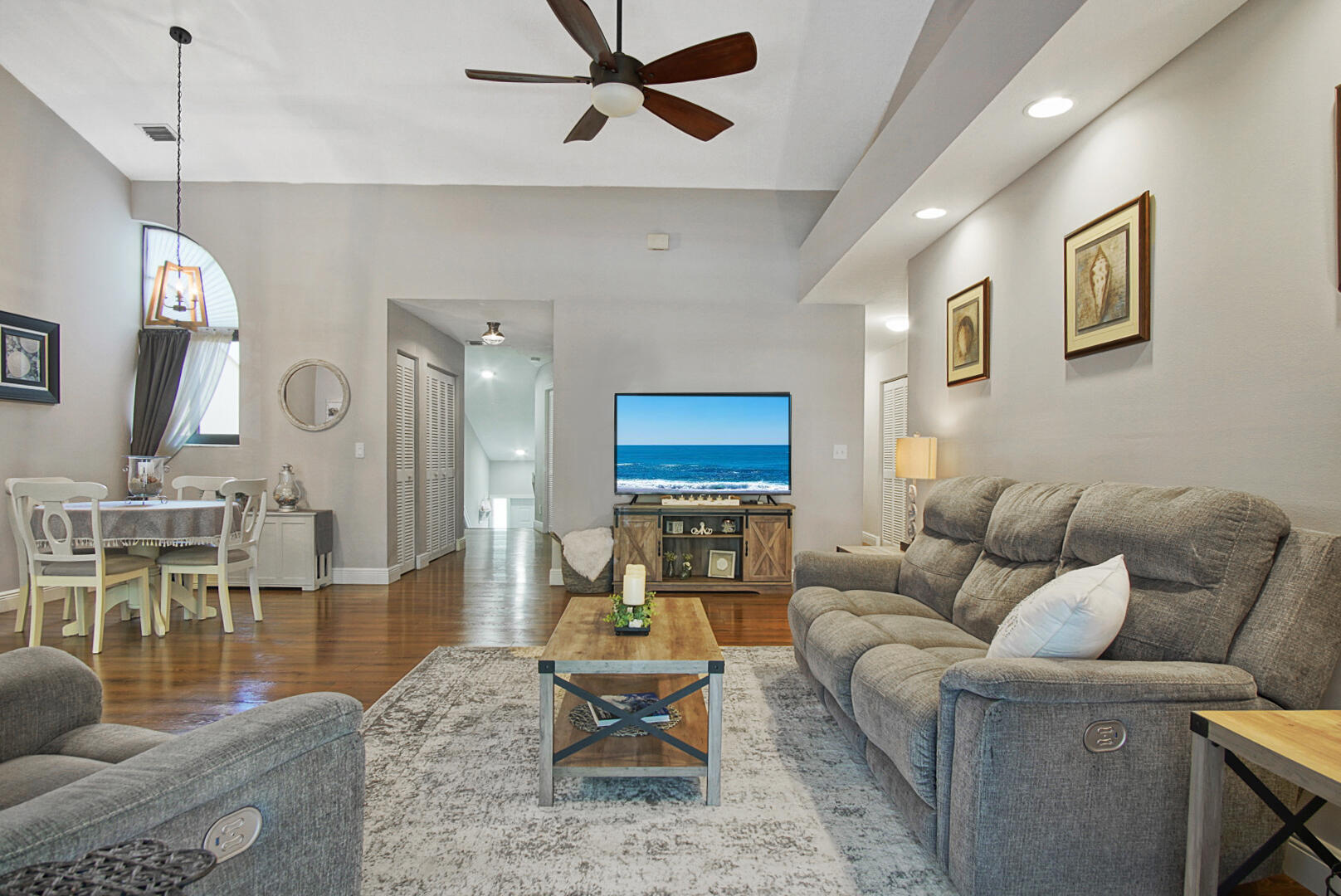 17308 Boca Club Boulevard, Unit 1102 Boca Raton, FL 33487 - Photo 8 of 48 a living room with furniture wooden floor and a chandelier