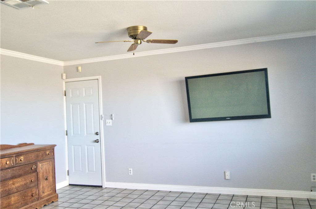 51063 Joshua Tree Road Johnson Valley, CA 92285 - Photo 22 of 35 This is the far end of the living room. The door leads into the HUGE attached garage! The garage is the same size as the house. It would be super easy to add a third bedroom out there and the prior owner told me that the HVAC system could easily handle the extra load.