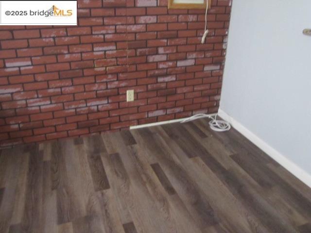 1943 South Ranchero Road Valley Springs, CA 95252 - Photo 19 of 23 Detailed view of wood finished floors and brick wall