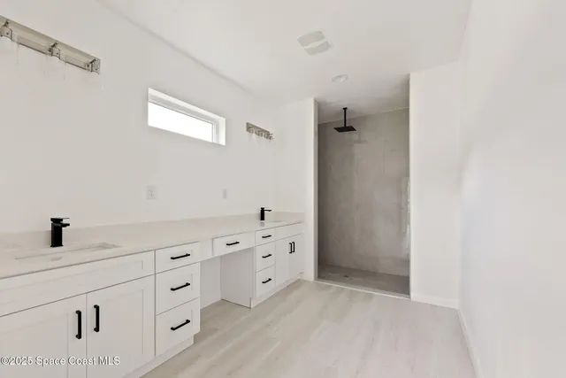 a bathroom with a bathtub sink and mirror
