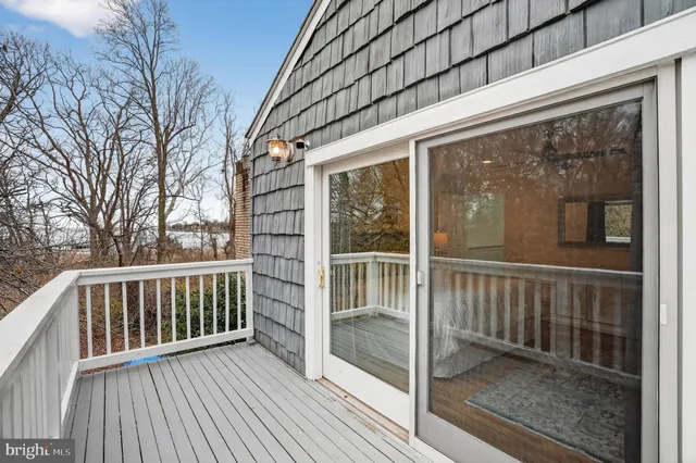 a view of swimming pool with outdoor seating and lake view