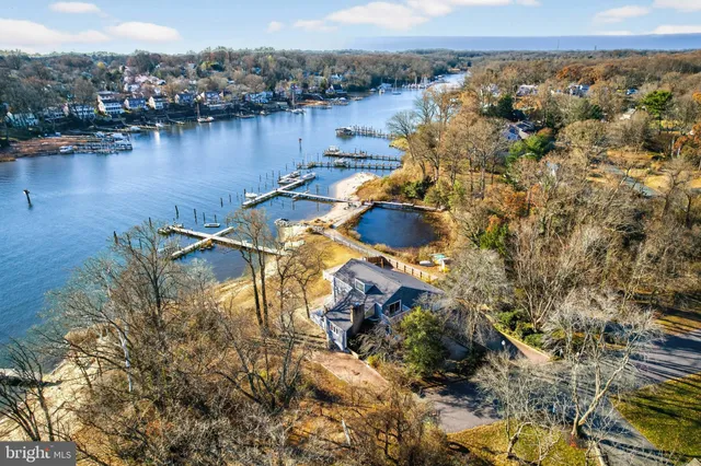 a view of a house with a small yard and wooden fence