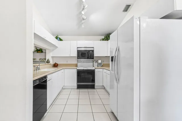 a kitchen with a refrigerator a sink and dishwasher