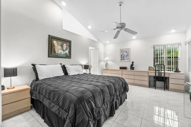 a spacious bedroom with a bed a couch and dresser