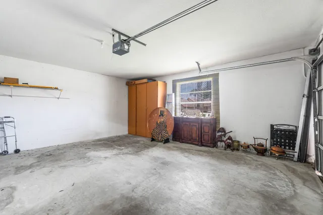 a view of an empty room with a fireplace and a window