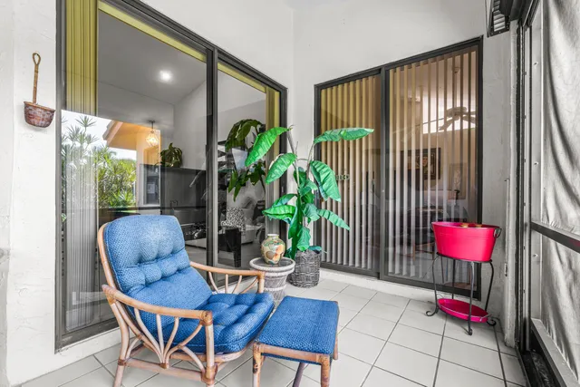 a dining room with furniture and a potted plant