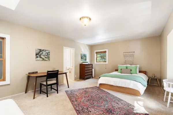 a bathroom with a sink a bed and a chandelier