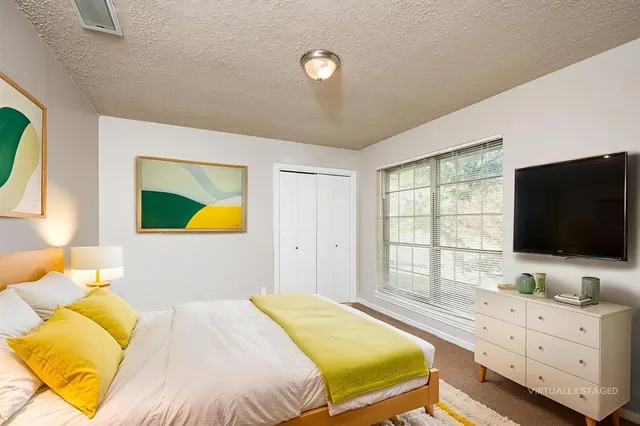 a bedroom with a bed and flat screen tv