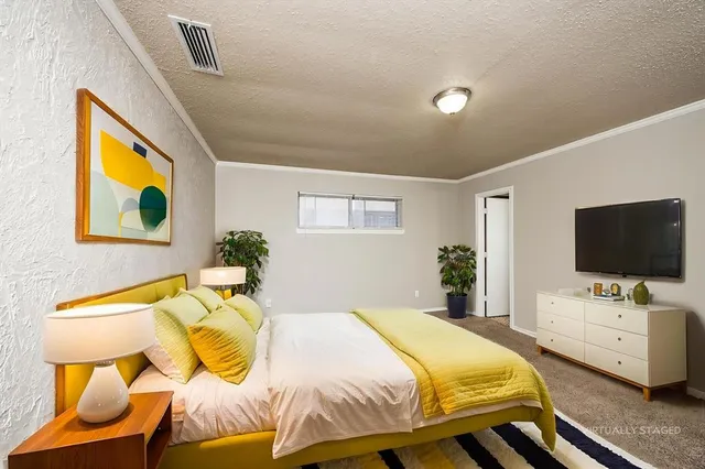 a bedroom with a bed and flat screen tv