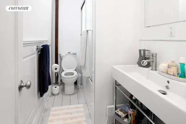 a bathroom with a sink a toilet and a shower