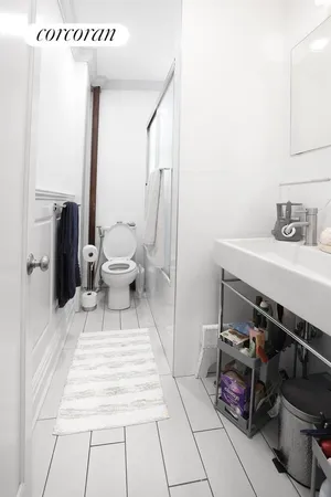 a bedroom with a bed and a mirror