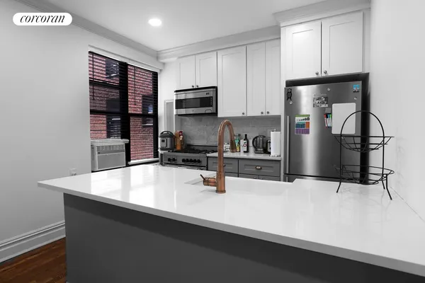 a kitchen with stainless steel appliances a sink stove and refrigerator