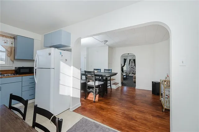 a kitchen with stainless steel appliances refrigerator dining table and chairs