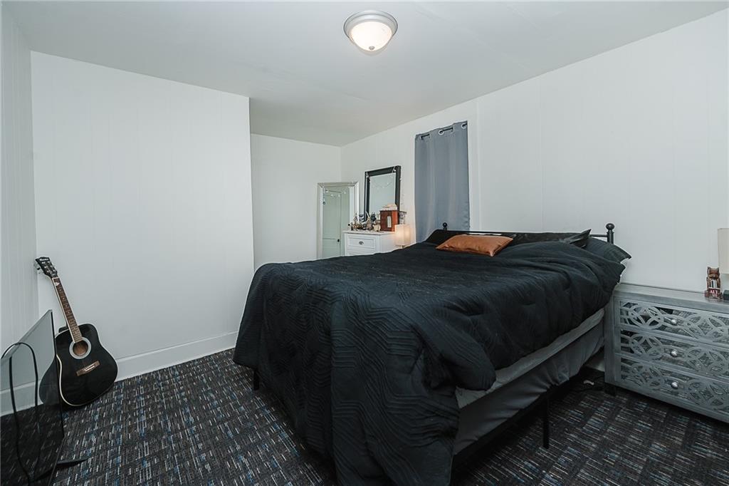 916 Main Street East Rural Valley, PA 16249 - Photo 14 of 32 a bedroom with a bed and wooden floor